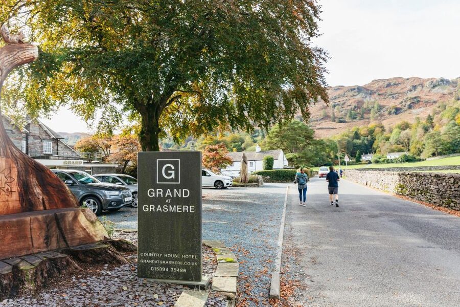 From Manchester: Lake District Bus Tour & Windermere Cruise - Coniston Water and the road through the hills