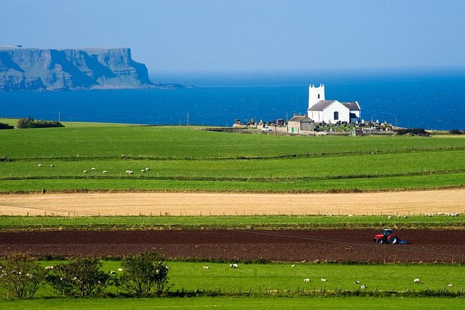 Giant's Causeway Full Day Tour from Belfast - Dunluce Castle, perched above the sea